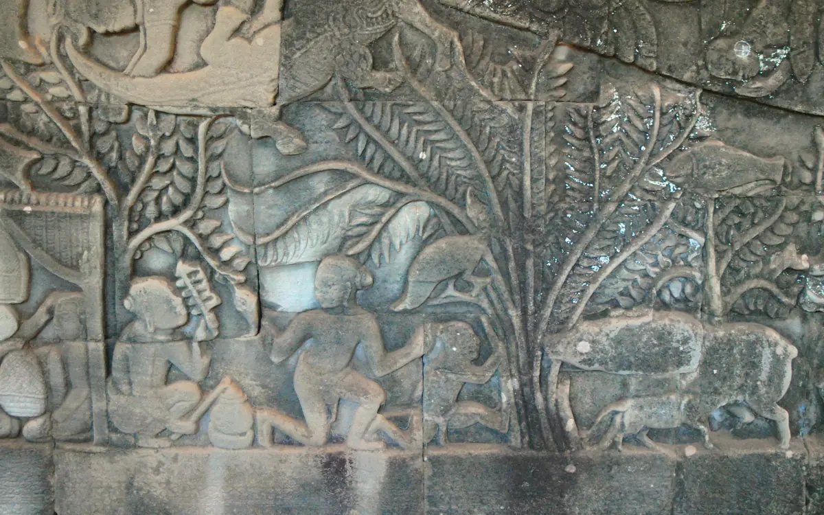 Bas-relief at the Bayon with figures and trees showing everyday activity