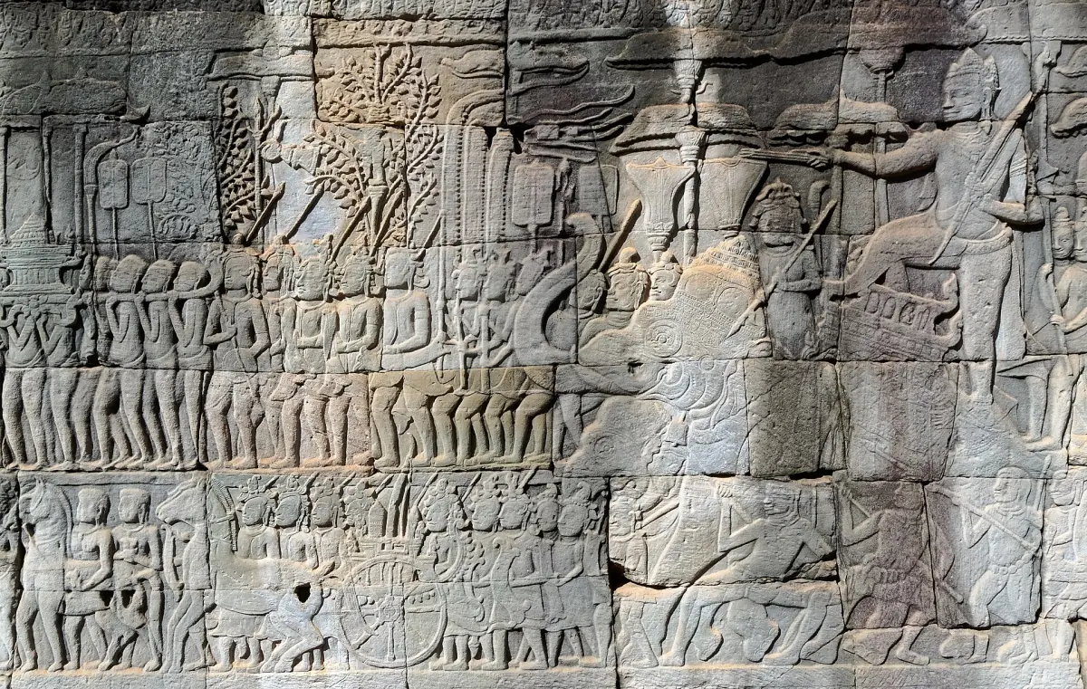 Wall of the Bayon covered with carved bas-relief scenes in rows