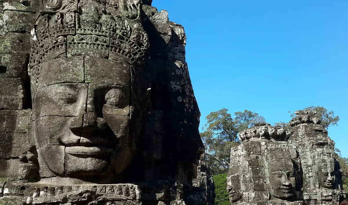 Close view of a serene stone face carved on a Bayon tower
