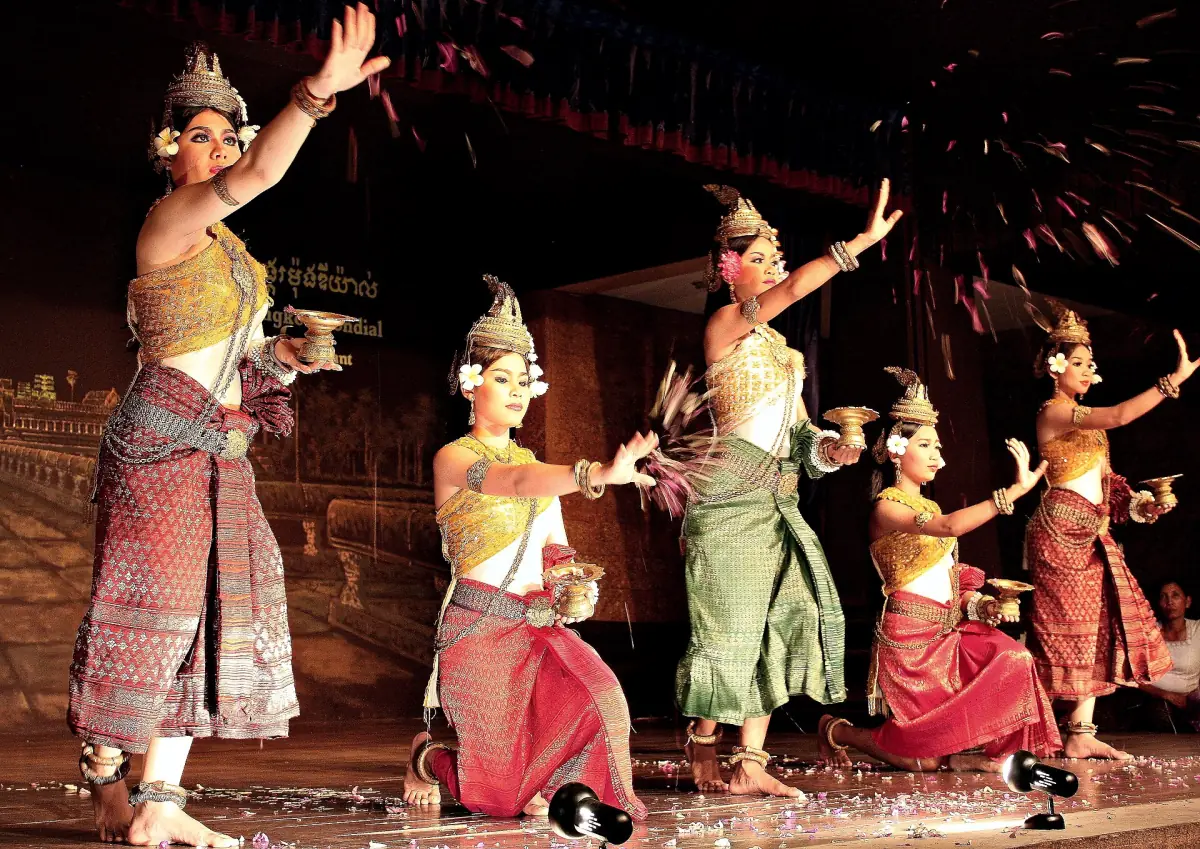 Khmer dancers in traditional costume performing on a lit stage