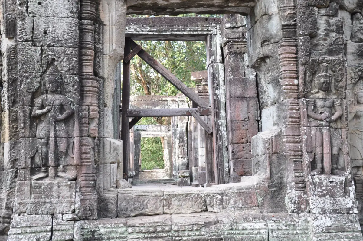 Stone doorway at an Angkor temple propped with wooden timber supports