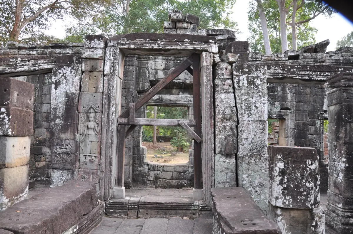 Wooden bracing holding up a stone gateway inside an Angkor temple